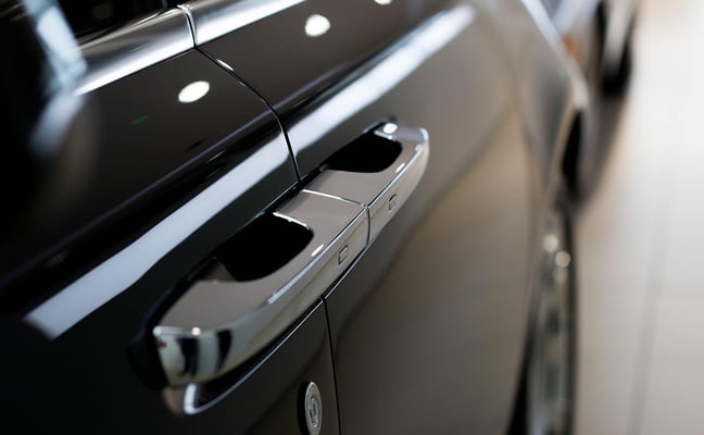 Close-up of black SUV door handle and chrome trim with LED lights
